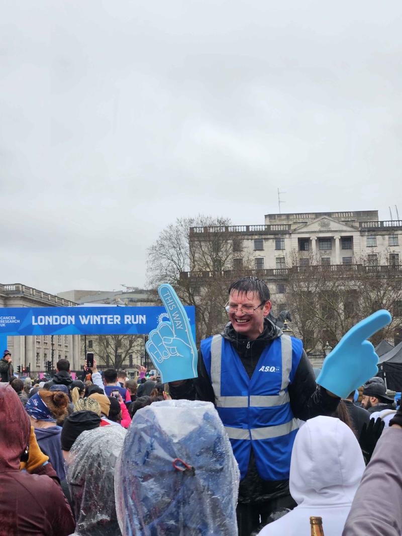 Volunteer with a foam finger giving high fives